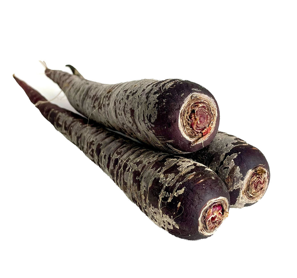 Three purple carrots on a white background